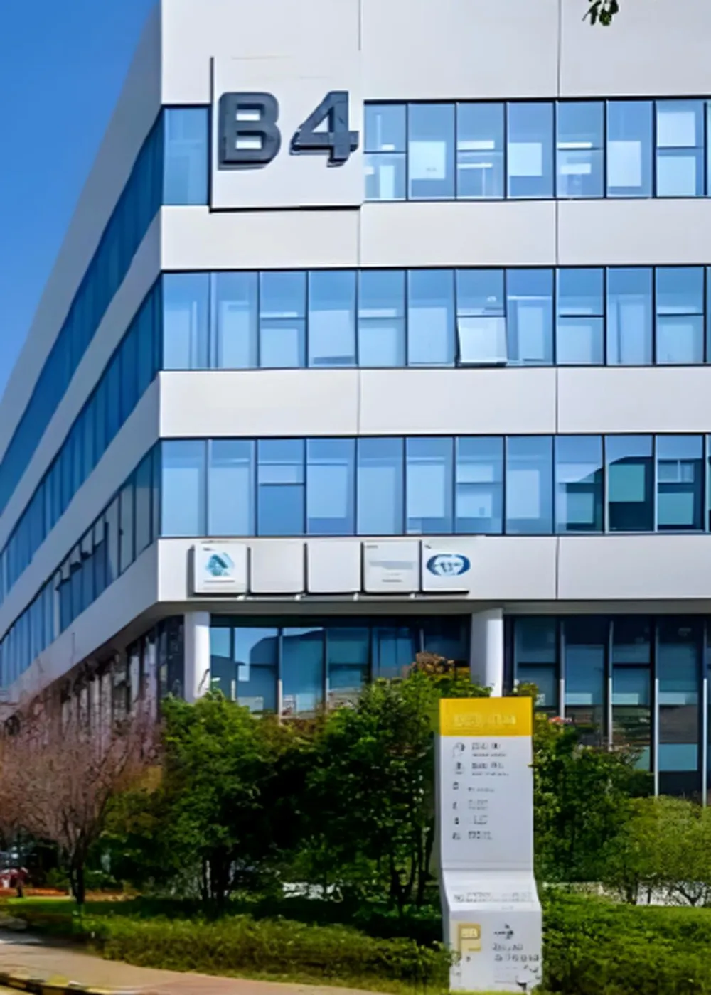 Modern industrial-park office building with a glass curtain wall